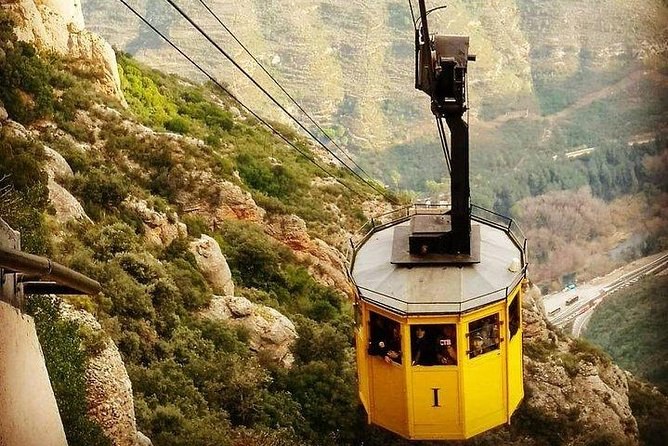 A cabin of the Aeri de Montserrat cable car crossing the valley on its wire