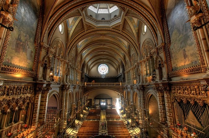 Inside the basilica at Montserrat, looking down the painted nave towards the altar