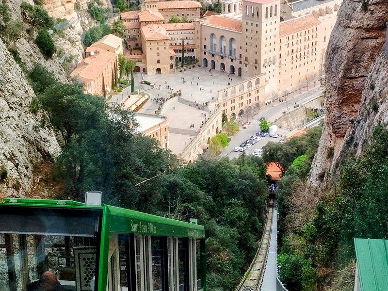 A funicular car on its track climbing the mountainside above the monastery at Montserrat