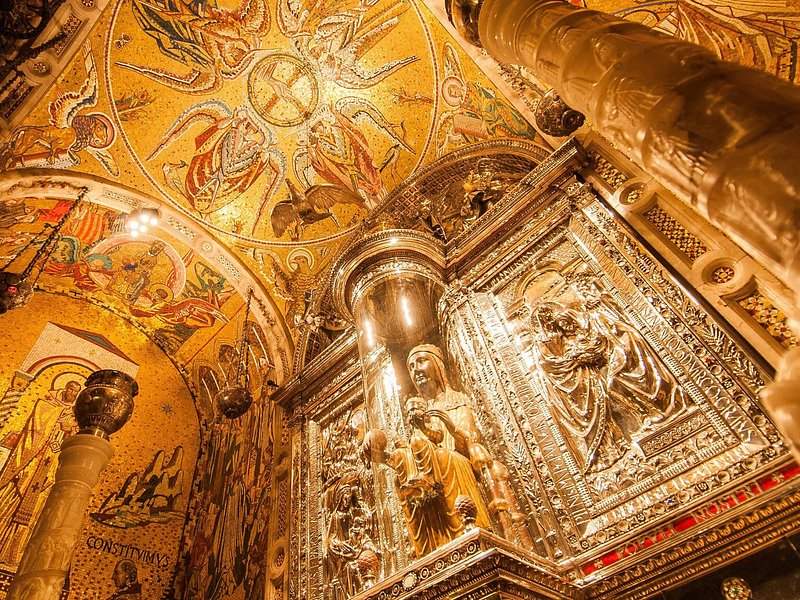 Gilt and mosaic work around the throne where La Moreneta sits above the altar