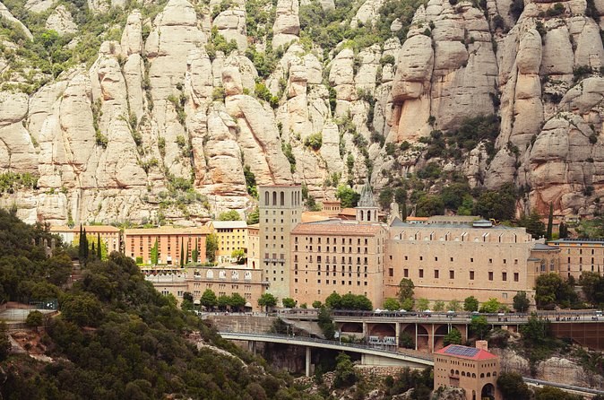 Montserrat monastery high above the valley floor, the rock walls behind it