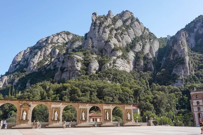 Rock needles rising above the arcade at the entrance to the basilica at Montserrat
